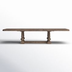 an old wooden table with two legs and a long slab on the top, against a white background