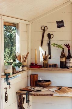 a room filled with lots of clutter on top of a wooden shelf next to a window