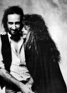 black and white photograph of a man hugging a woman's head with long hair