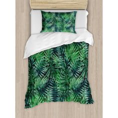 an image of a bed with green leaves on it