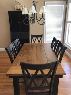 a dining room table with chairs and a chandelier