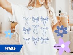 Embrace the coquette aesthetic with this adorable design featuring girly light blue bows, perfect for those who love all things sweet and stylish.  Comfort Colors Tee available in up to a size 4XL in 6 feminine colors. 🙃ITEM SIZING🙂 - Please READ. Please refer to the images for size charts.  Please remember that this is Unisex (men's) sizing.  We recommend sizing up 2 for the oversized look.  If there is no picture of a design on the front of the garment, the front is blank.  The design does s Cute White Top With Bow, Cute White Top With Bow Detail, Cute Blue T-shirt For Gift, Trendy White Tops With Bow Print, Trendy White Top With Bow Print, Feminine Colors, Bows Coquette, Soft Girl Era, Light Blue Ribbon