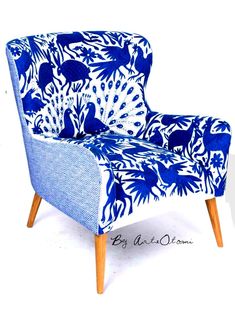 a blue and white patterned chair with wooden legs