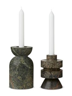 two marble candlesticks sitting next to each other on top of a white background