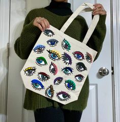 These hand painted optic totes are one of a kind Each bag is hand painted with love and completely original. No bag is exactly alike. Order today to receive a unique tote created with care! Allow me 1-3 weeks to complete and ship! As they are handmade, and only created upon order, I need this time to perfect your bag and have it completely dry before shipment! Care instructions: these totes are painted with a fabric medium but I do not suggest washing them or getting them wet!! spot clean if nec Handpainted Totes, Handpainted Tote, Diy Tote Bag Design, Painted Canvas Bags, Handpainted Tote Bags, Totes Ideas, Painted Purse, Wet Spot, Handpainted Bags