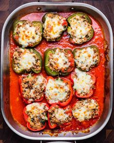 stuffed peppers in a pan with cheese on top