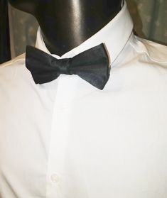 Black bow tie in silk. Measuring to fit up to 22 inch necks. Bow is 4.75 inches wide across and 2.25 inches wide at the widest height. Black bow tie AE Black Bow Tie, Silk Bow Ties, Silk Bow, Black Bow, Bow Ties, Black Silk, Bow Tie, Silk, Black