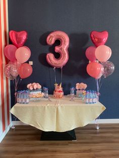 the table is set up with balloons and decorations for an 30th birthday party or baby's first birthday