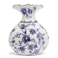 a blue and white vase with flowers on the bottom is sitting in front of a white background