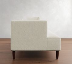 a white couch sitting on top of a wooden floor