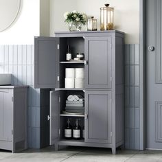 a bathroom with a gray cabinet next to a sink