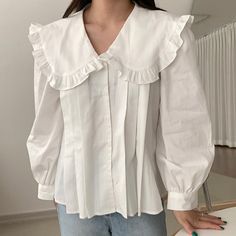 Long sleeve blouse with a pleated front and frilly oversized peter pan collar. Perfect statement piece on its own or layered under your favorite piece of choice. S: 14" across shoulders, 34.5" chest, 24" length M: 14.5" across shoulders, 36" chest, 24" length L: 15" across shoulders, 37.5" chest, 24.5" length XL: 15.5" across shoulders, 39" chest, 24.5" length Big Collar Shirt Women, Collar Button Up Shirt Outfit, Big Collar Blouse Outfit, Peter Pan Collar Blouse Outfit, Oversized Collared Shirt Outfits, Peter Pan Collar Outfit, White Blouse With Collar, Collar Blouse Outfit, Oversized Blouse Outfit