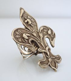 "Vintage Jewelry - Vintage Ring - Art Nouveau Jewelry - Fleur de Lis Ring - Vintage Brass Jewelry - Statement Ring - handmade jewelry This is such a cool ring! A gorgeous large Art Nouveau Fleur de Lis design set on a wide floral adjustable ring band. All USA vintage brass. It is adjustable and can fit on any finger. Just gorgeous! Chloe says, \"Wear it and feel fabulous!\" The ring measures stunning 2 1/4\" long and 1 1/2\" wide. Adjustable up to size 9. *Thank you for visiting Chloe's*" Handmade Bronze Rings For Collectors, Art Nouveau Sterling Silver Rings As Gift, Art Nouveau Sterling Silver Rings As A Gift, Art Nouveau Sterling Silver Gift Rings, Handmade Adjustable Antique Rings, Silver Art Nouveau Ring As Gift, Silver Art Nouveau Ring For Gift, Unique Bronze Rings For Gifts, Unique Bronze Rings For Gift