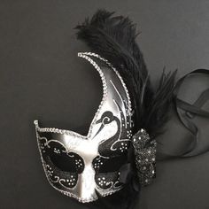 The swan-inspired black/silver mask for women has arching feathers. Mask Ball Party, Silver Masquerade Mask, Mask Ball, Wedding Mask, Silver Mask, Feather Mask, Party Mask, Female Mask, Ball Party