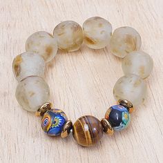 a beaded bracelet with glass beads on a wooden surface