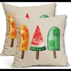 two pillows with watermelon, orange and lime popsicles printed on them