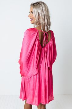 You will be impeccably dressed when you wear this chic pink dress featuring ultra lightweight flowy satin material, a draped overlaid bodice that cascades into long oversized bat wing sleeves with high underarm slits and elastic band cuffs, a deep v-cut neckline and upper back with a tie closure, and an ultra relaxed silhouette that falls into an uneven mid-thigh length hemline!                                   Measurements S variant has  a Bust of 32",  a Hip of 38",  a Length of 33",  a Sleev Silk Draped Dress With Ruched Back, Satin Dress With Pleated Back For Night Out, Pink Bridesmaid Dress With Flowy Skirt, Summer Satin Maxi Dress With Pleated Back, Chic Draped Dress With Ruched Back, Flowy Evening Dress With Ruched Back, Ruched Dress With Flowy Skirt For Night Out, Pink Elegant Mini Dress With Ruched Back, Elegant Pink Mini Dress With Ruched Back