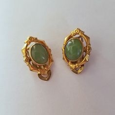 This is a pair of vintage estate jade earrings made in the 60's in their original box. They are genuine with ornate 12K gold filled oval frames. Art Deco Oval Earrings For Formal Occasions, Oval Art Deco Earrings For Formal Occasions, Formal Oval Art Deco Earrings, Vintage Green Cabochon Earrings, Antique Brass Oval Earrings, Antique Oval Brass Earrings, Victorian Gold Cabochon Earrings, Vintage Oval Earrings Hallmarked, Gold Victorian Cabochon Earrings