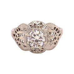 an antique style diamond ring with filigrees