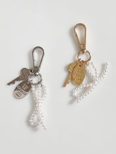 two key chains with charms attached to them