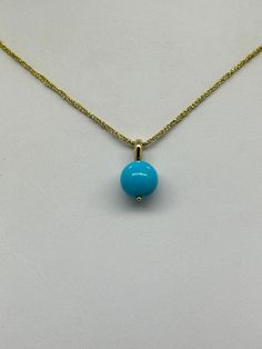 Sleeping Beauty Turquoise Bead Pendant.  This hand made pendant features a Robins Egg Blue Sleeping Beauty Turquoise Bead Round Polished 10mm mounted on a 14K yellow gold solid bail 3 X 4.2mm I.D. The pendant measures 11/16 inch.  The Turquoise Bead is Genuine and Natural in color, no dyes, it has been stabilized to protect its color.  This pretty minimalist pendant can be worn alone or layered with your favorite pieces.  The pendant pictured is the one you will receive.  NO CHAIN IS INCLUDED.  It will arrive in a nice presentation box with a Certificate of Authenticity.   Please visit our Shop for more Pearls and Gemstone Jewelry. Elegant Yellow Gold Turquoise Pendant Necklace, Yellow Gold Turquoise Necklace With Round Beads As Gift, Elegant Yellow Gold Turquoise Necklace With Cabochon, Elegant Yellow Gold Turquoise Cabochon Necklace, Gold Turquoise Pendant Necklace With Cabochon, Elegant Turquoise Necklace With Round Pendant In Yellow Gold, Elegant Yellow Gold Turquoise Necklace With Round Pendant, Gold Turquoise Necklace With Polished Beads As Gift, Elegant Turquoise Necklace With Polished Beads As Gift