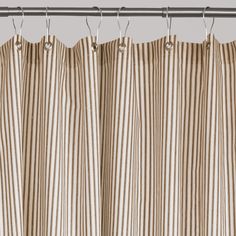 a striped curtain hanging from a metal rod