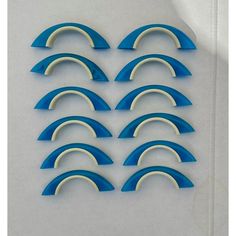 six blue and white surfboards are arranged in a row on a gray background,