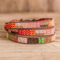 multicolored beaded bracelets stacked on top of each other with wooden beads