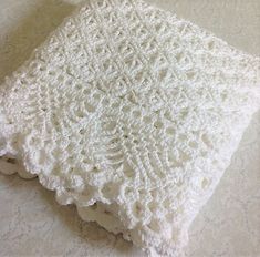 a white crocheted dishcloth sitting on top of a table