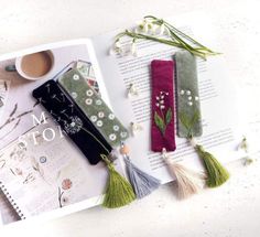 the bookmarks are decorated with flowers and tassels, along with a cup of coffee