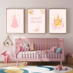 a baby's room with pink walls and posters on the wall