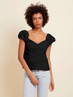 The name says it all. With a sweetheart neckline, buttons down the front and a cute bubble sleeve, it's just the girly touch your outfit needs. (This one comes in Jet Black.) | Angel Top in Jet Black | Ethical Essentials Fitted Cotton Flirty Tops, Fitted Flirty Cotton Tops, Fitted Cotton V-neck Puff Sleeve Top, Flirty Fitted Short Sleeve Blouse, Sweetheart Neckline Top For Date Night In Spring, Fitted Flirty Top With Puff Sleeves, Fitted Flirty Puff Sleeve Top, Flirty Fitted Puff Sleeve Top, Fitted Cotton Puff Sleeve Top With Gathered Sleeves