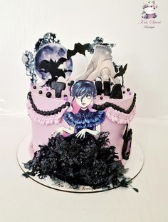 a pink and black cake with bats on it