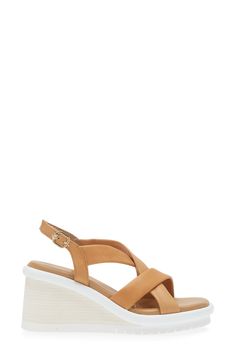 Buttery-soft leather straps cross at the vamp of a breezy sandal lofted by a chunky wedge. 3" heel; 1 1/2" platform (size 39) Adjustable slingback strap with hook-and-loop closure Cushioned insole Leather upper and lining/synthetic sole Imported Summer Slingback Wedge Sandals With Padded Heel, Spring Leather Wedge Heel Slingback Sandals, Leather Slingback Wedge Sandals For Spring, Spring Leather Slingback Wedge Sandals, Spring Slingback Wedge Sandals With Wooden Heel, Modern Synthetic Wedge Sandals With Wooden Heel, Leather Sandals With Padded Heel And Cross Strap, Synthetic Wedge Sandals With Heel And Cross Straps, Synthetic Wedge Sandals With Cross Strap And Heel Strap