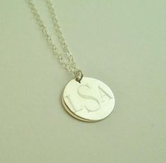 "This sterling silver necklace makes a beautiful present for your wife, mother or friend. They are also perfect for for bridesmaids presents. I will engrave a monogram or name onto the round pendant. Pendant - Sterling Silver, 3/4\" diameter Necklace- Sterling Silver, 16\" long (if you prefer longer or shorter please request at checkout, for up to 20\" there is no additional charge, longer will be charged $2 per inch) How to Order: 1. Place item or items in cart. (If purchasing more than one ite Sterling Silver Initials Medallion Necklace, Sterling Silver Medallion Necklace With Initials, Sterling Silver Initial Pendant Necklace With Engraving Option, Sterling Silver Initial Pendant For Bridesmaid, Sterling Silver Initial Pendant Jewelry For Bridesmaid, Adjustable Sterling Silver Initials Name Necklace, Silver Initial Pendant Necklace With Engraving Option, Adjustable Silver Name Necklace With Round Pendant, Silver Name Necklace With Round Pendant