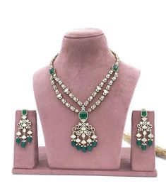 Indulge in the timeless elegance of our "Radiant Bride" Necklace, meticulously crafted to adorn the neck of a discerning bride with unparalleled beauty and grace. This opulent necklace features a harmonious fusion of exquisite moissanite, shimmering American diamonds, and a captivating green stone, all set against a backdrop of premium quality mehendi polish. Elevate your bridal ensemble to new heights of sophistication with this stunning piece that exudes luxury and refinement. Materials: Moiss Fusion Style Diamond Kundan Necklace For Wedding, Formal Bridal Necklace With Diamond And Tilla, Formal Bridal Necklace With Tilla And Diamonds, Formal Bridal Diamond Necklace With Tilla, Kundan Diamond Necklace With Tilla For Wedding, Silver Bridal Necklace With Elegant Design For Festivals, Festival Bridal Necklace With Elegant Design In Silver, Silver Bridal Sets For Diwali Reception, Festive Silver Bridal Necklace With Elegant Design