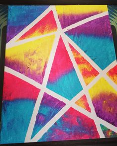 an abstract painting with white lines and bright colors on the paper that has been painted