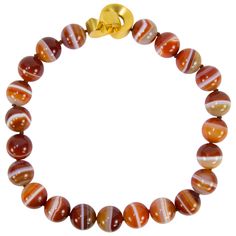 Stunning Large Carnelian Banded Agate Bead Necklace comprising twenty-four 19.55mm beads; held by a unique bold Gilt Sterling Silver clasp; newly hand knotted with Silk cord. Stylish and Dynamic…illuminating your look with Timeless Beauty! Runway Necklace, Blue Agate Stone, Necklaces Beaded, Carnelian Necklace, Artisan Bracelets, Vintage Beads Necklace, Coach House, Jasper Necklace, Gold Statement Necklace