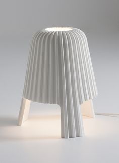 a white lamp that is on top of a table