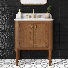 a bathroom vanity with marble top and gold faucet, against a black tiled wall