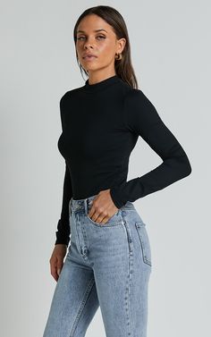 Elevate your wardrobe with the Elmira Bodysuit, our must-have staple for fashion-forward babes. This long sleeve high neck bodysuit in classic black is a versatile piece that belongs in every girl's closet. Made from soft jersey fabric and crafted with care from polyester, this bodysuit offers both comfort and style. Whether you're dressing it up or keeping it casual, its high standard of quality ensures that you'll look effortlessly chic no matter the occasion. Pair this essential basic with je High Neck Black Bodysuit For Winter, Winter Turtleneck Bodysuit For Workwear, Sleek Black Bodysuit For Fall, Sleek Long Sleeve Winter Bodysuit, Winter Workwear Turtleneck Bodysuit, Chic Black Bodysuit With Thumbholes, Trendy Black Bodysuit With Thumbholes, Black High-neck Bodysuit For Fall, Trendy Black High Neck Bodysuit