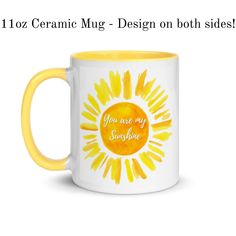 a yellow and white coffee mug with the words you are my sunshine on it