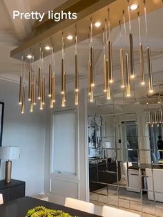 a modern chandelier hanging over a dining room table