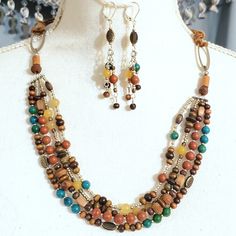 Lovely Set With 3 Kinds Of Semiprecious Stones: Chrysocolla (Blue/Green); Egg Yolk Amber (Yellow); Red Jasper (Orange/Red). Necklace: 4 Strands Of Beads, Each With 6mm, Finished, Semiprecious Stones; Wooden Beads In Varying Sizes; Glass Seed & Metal Spacer Beads; Metal Oval Rings; Suede Cord, Knotted To Allow For Adjustable Wear; Toggle Closure. : Inside Circumference = 22" Earrings: Same Bead Mix With Lever Back : Drop = 3" Red Necklace, Bead Set, Crafts Jewelry, Suede Cord, Oval Rings, Diy Crafts Jewelry, Bead Stringing, Egg Yolk, Red Jasper