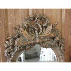 an ornate mirror hanging on the side of a wooden door