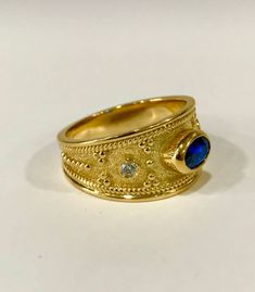 An Eye-Catching Medieval Ring with Shiny Gemstones on top. Gold Byzantine Ring - Sapphire Ring - Medieval Ring - Etruscan Ring - Danelian Jewelry Following fine techniques to bring to life according to Etruscan & Byzantine design. ◾ Dimensions: 10.5mm width at the top. ◾ Bottom: 4.5mm width ◾ Materials: Choose your desired material for your ring, (Sterling Silver 925, 9K Solid Gold, or 14k Solid Gold). 18K Solid Gold option is also available, message us! Sterling Silver 925 option is availab Byzantine Engraved Round Ring For Anniversary, Byzantine Engraved Ring For Anniversary, Byzantine Engraved Anniversary Ring, Byzantine Ring With Bezel Setting For Gift, Gold Byzantine Ring With Bezel Setting, Wedding Rings With Byzantine Intricate Design, Byzantine Wedding Rings With Intricate Design, Ceremonial Byzantine Rings With Historical Design, Byzantine Style Oval Anniversary Rings