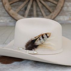 This handmade arrangement of feathers is the perfect way to set your hat apart from the rest. Simply tuck into the band of any hat. Made with a mix of pheasant and rooster feathers.  Includes: 1 Handmade Arrangement of Feathers. How to use: Tuck into the hat band of any hat. *Each one will vary slightly due to being handmade. Approximately 5-6 inches in length. *Hat not included.  Natural Feathers * Approx. 5 inches - sizes may vary slightly * Tuck into the band of any hat! * *Hat not included* Feathered Short Brim Hat Bands For Western-themed Events, Feathered Hat Bands For Western-themed Events, Brimmed Hat Bands With Feathers For Rodeo, Southwestern Feather Hat Band For Country Events, Feathered Flat Brim Hat Bands For Rodeo, Fedora Hat Bands With Feather Trim For Country Events, Southwestern Hat Bands With Feathers For Ranch, Western Hat Bands With Feathers For Rodeo, Feathered Felt Hat With Flat Brim For Western-themed Events