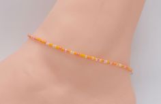 .  Beach Anklet, Beaded Anklet, Anklet Jewelry, Ankle Bracelet, Boho Anklet, Hippie Anklet, Gift For Her, Women's, Orange Anklet Dainty anklet is made with 11/0 Czech seed beads in different shades of orange and off white, with 2mm silver filled beads with a lobster clasp.  All items in my store are made buy me. Please send me a message if you want a custom order or need a size that is not listed in the drop down menu.  Size: Measure your anklet above the anklet bone with measuring tape. With th Dainty Anklet, Orange Bracelet, Beaded Anklet, Anklets Boho, Beach Anklets, Women Anklets, Diy Bracelets Easy, Bracelet Women, Beaded Anklets