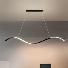 a modern light fixture hanging from the ceiling