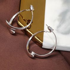 The classic circle shape, with its careful mechanism, two semicircles outline a ring, hanging between the ears at different angles will present different shapes, each angle has its beauty, concise and capable without losing the modern sense of collocation. Lookfashionable and elegantwith these gorgeous Simple Curved Earrings!! Features Small and lightweight- Wear or carry it around with you for a variety of earring options wherever you go. Wide application- Suitable for both everyday use and special occasions like parties, clubbing, weddings, and more. Perfect gift idea- Great gift to give for all ladies like mothers, grandmothers, aunts, cousins, girlfriends, and more. Excellent material-S925 ear acupuncture material, comfortable to wear, not easy to allergies. Thick electroplating is not Elegant Open Circle Metal Jewelry, Metal Open Circle Hoop Earrings, Modern Nickel-free Open Circle Hoop Earrings, Formal Circular Metal Earrings, Semi-circle Metal Hoop Earrings, Modern Metal Open Circle Hoop Earrings, Minimalist Open Circle Metal Earrings, Minimalist Metal Open Circle Earrings, Elegant Semi-circle Metal Earrings